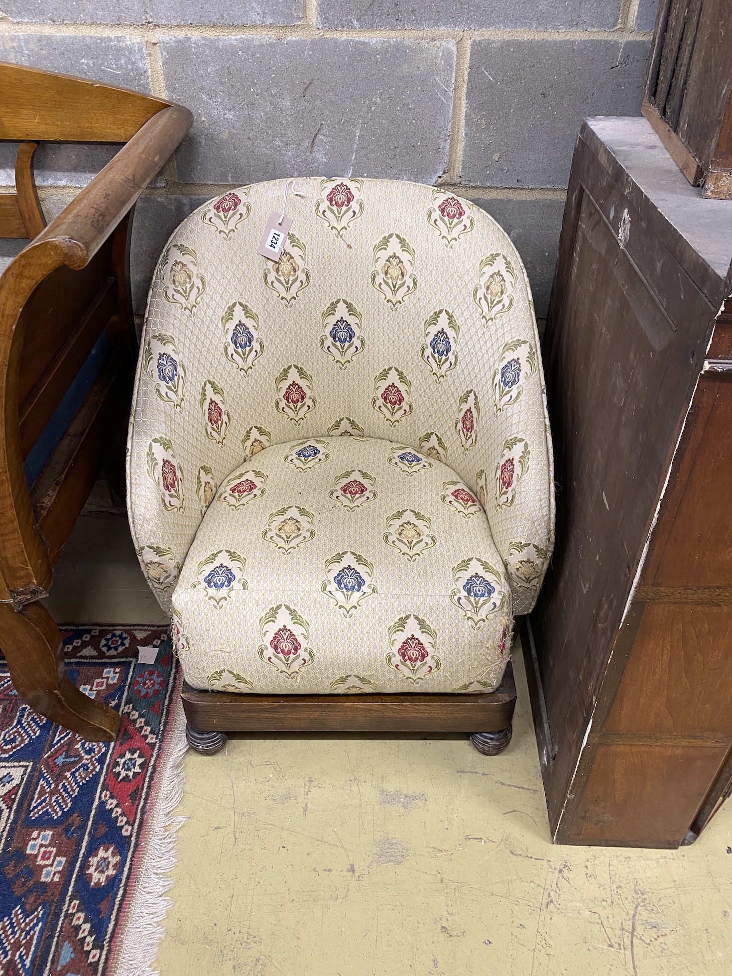 A 1920's tub framed upholstered child's chair, width 58cm, depth 60cm, height 70cm